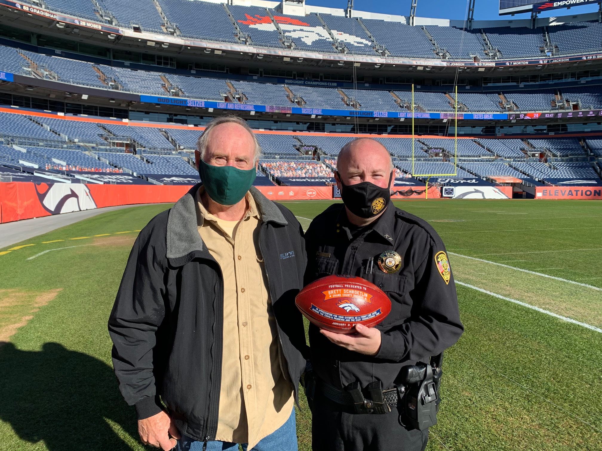 Grand County Sheriff Schroetlin with his Father Dave Schroetlin at Empower Field at Mile High