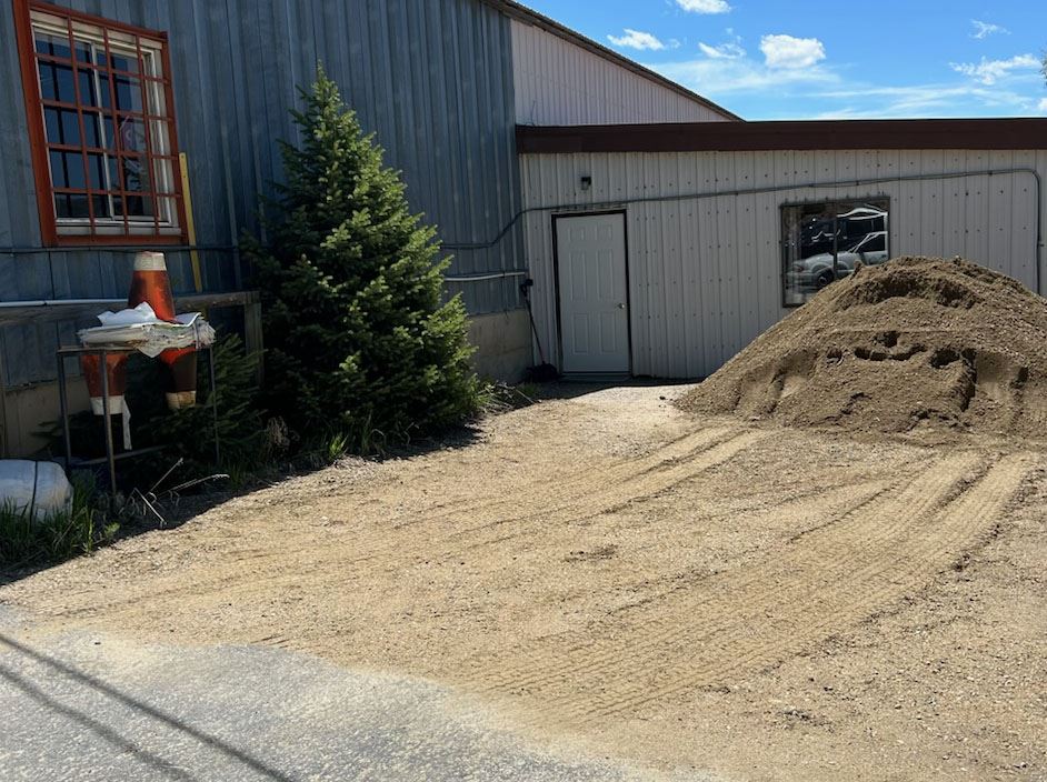 Pile of sand and sandbagging station at Granby Road and Bridge shop